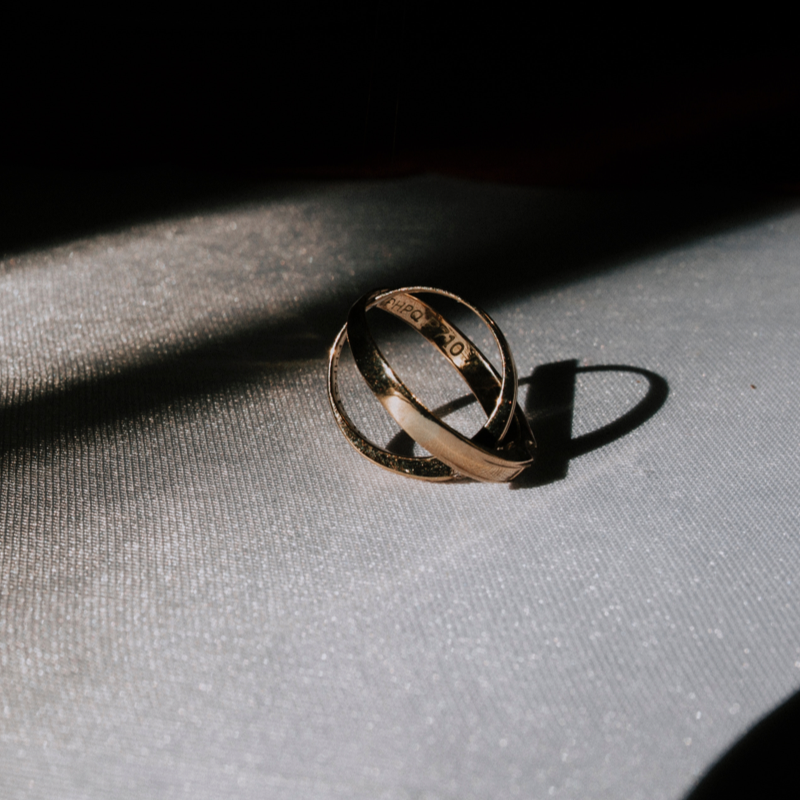 Two gold band rings with engraving inside the bands